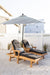 Berlin Gardens Comfo Back Chaise Lounges in Natural Teak. Cushions in Heritage Char. Pillows and Umbrella in Regatta Ebony