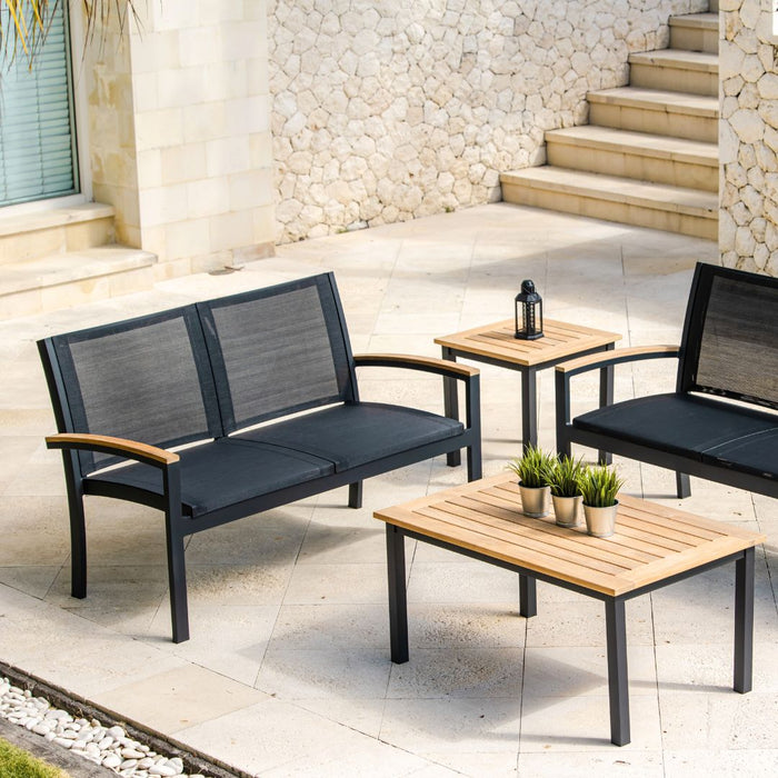 Three Birds Casual Tribeca 2-Seater Settee with other Tribeca pieces in a stone patio space