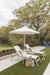 Vida Chaise Lounges and Vida Dining End Table in Sahara Speckle, sling in Sailing Salt. Throw pillows in Cast Ash. LilyHive Tasseled throw pillows in Luxe Stripe Sand